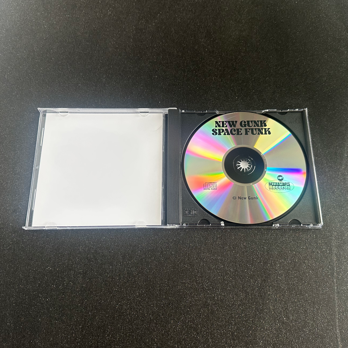 CD inside an open case on a black background. It reads "New Gunk Space Funk".